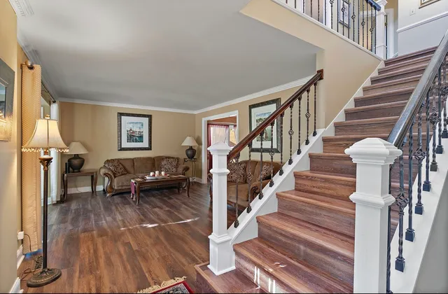 a view of entryway and hall with wooden floor