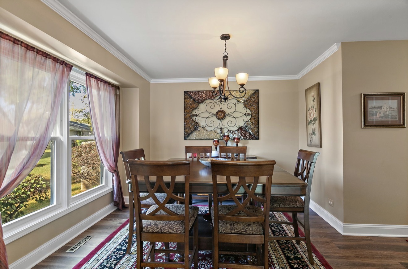 11612 Becky Lee Huntley, IL 60142 - Photo 7 of 33 a view of a dining room with furniture window and wooden floor