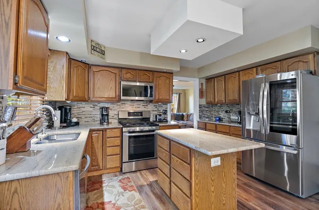 a kitchen with a stove sink and refrigerator