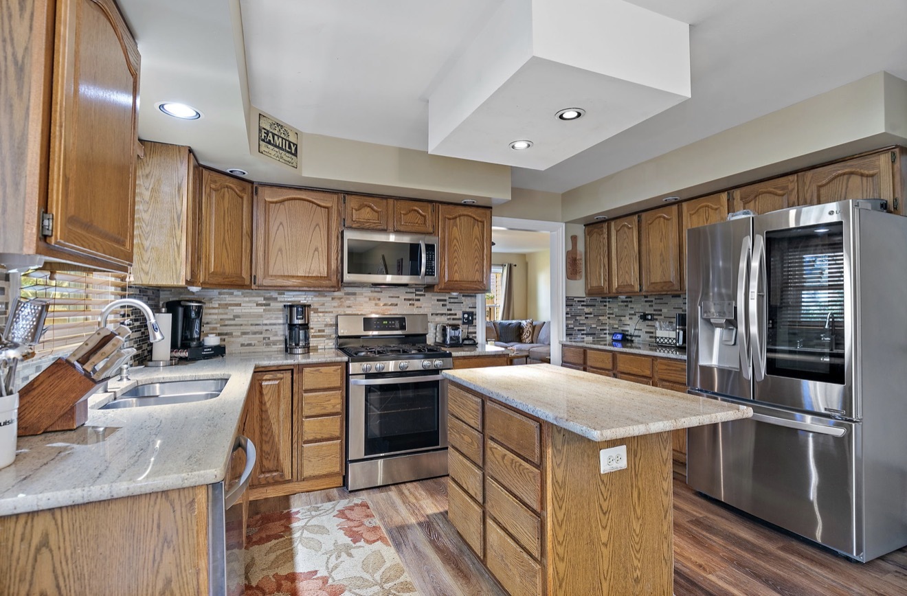 11612 Becky Lee Huntley, IL 60142 - Photo 10 of 33 a kitchen with a stove sink and refrigerator