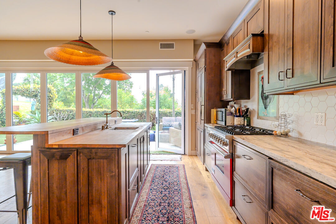 5903 Tellefson Road Culver City, CA 90230 - Photo 4 of 38 a kitchen with stainless steel appliances granite countertop a sink and a stove