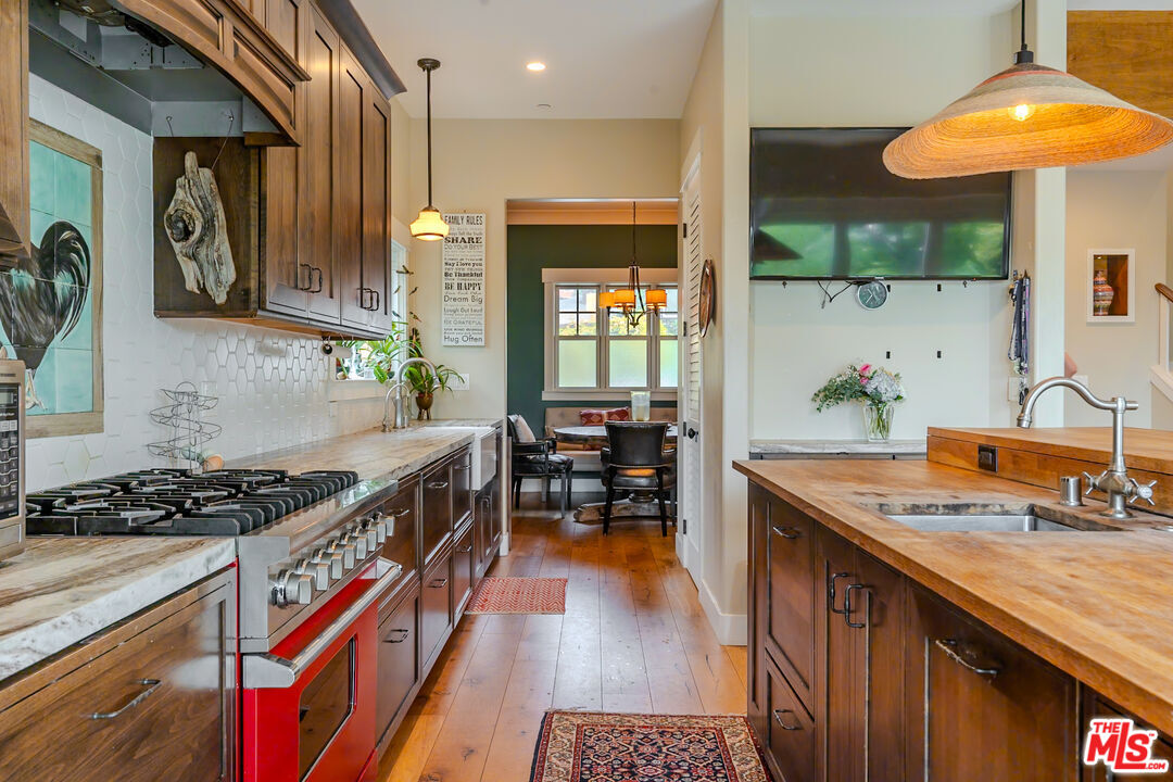 5903 Tellefson Road Culver City, CA 90230 - Photo 7 of 38 a kitchen with stainless steel appliances granite countertop a stove a sink and a wooden cabinets