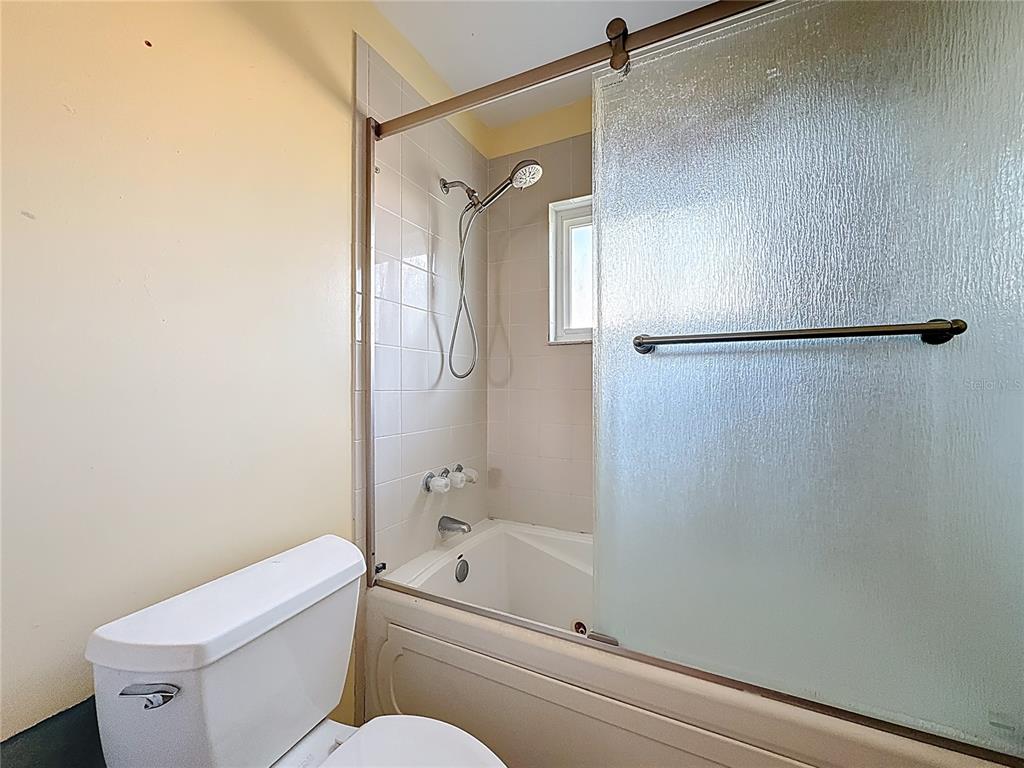 4869 Shell Stream Boulevard New Port Richey, FL 34652 - Photo 30 of 46 a bathroom with a shower a toilet and a sink