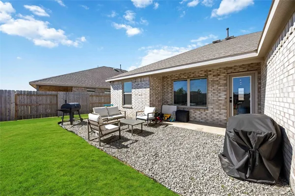 a view of a house with backyard sitting area and garden