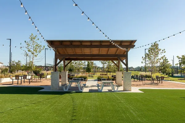 a view of a swimming pool with an outdoor seating and a yard