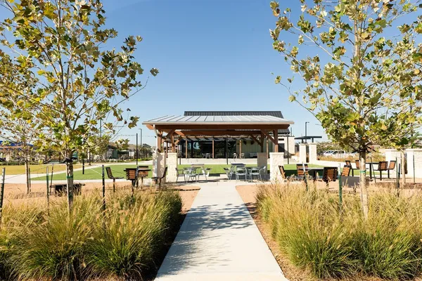 a view of swimming pool with outdoor seating and plants