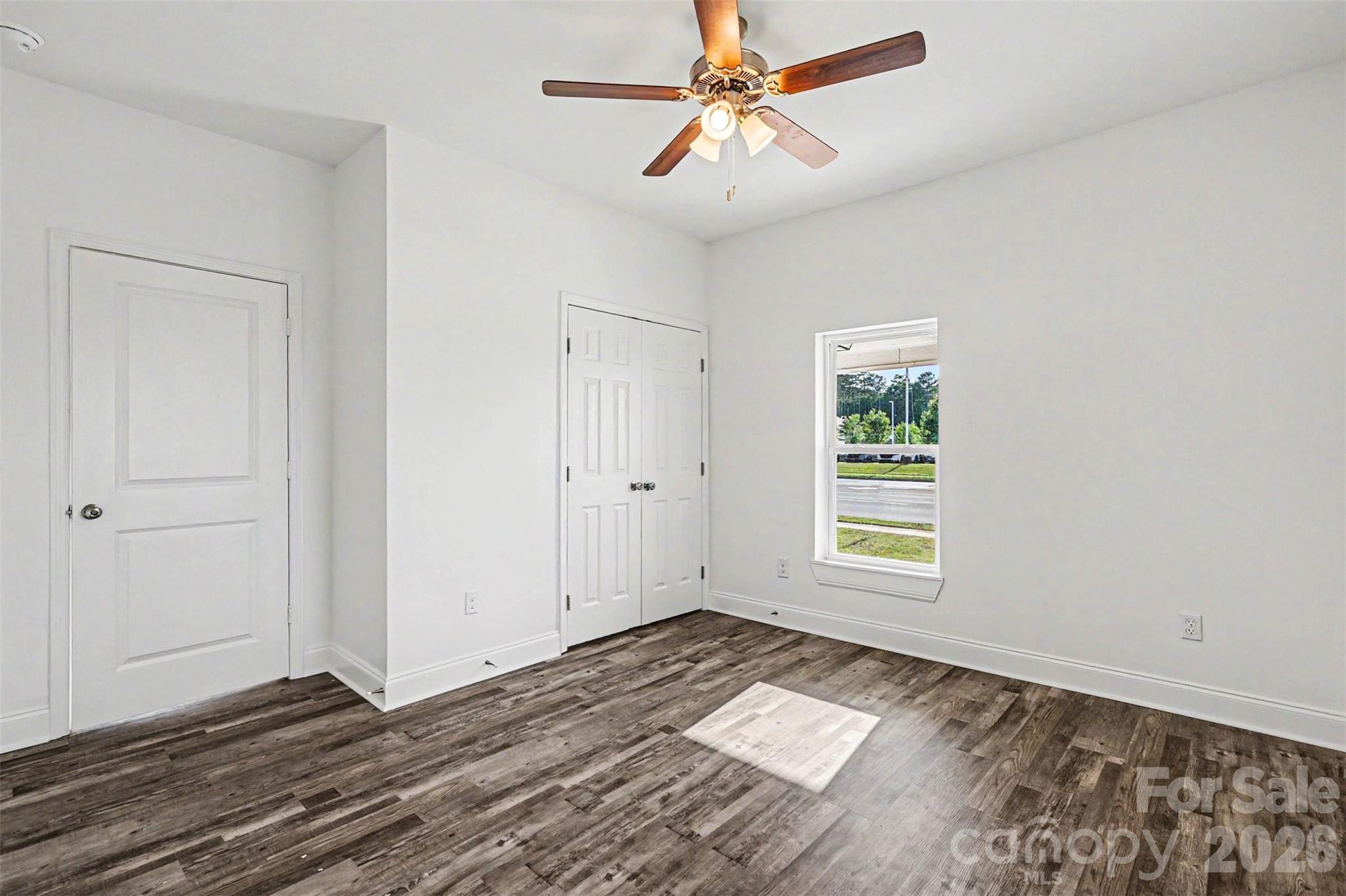 405 Aquadale Road Albemarle, NC 28001 - Photo 16 of 29 a view of empty room with wooden floor and fan
