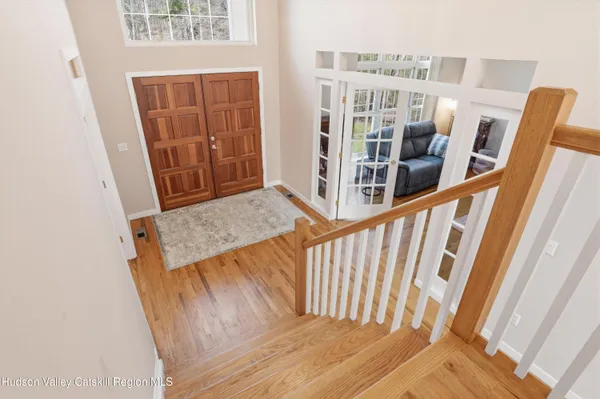 a view of entryway and hall with wooden floor