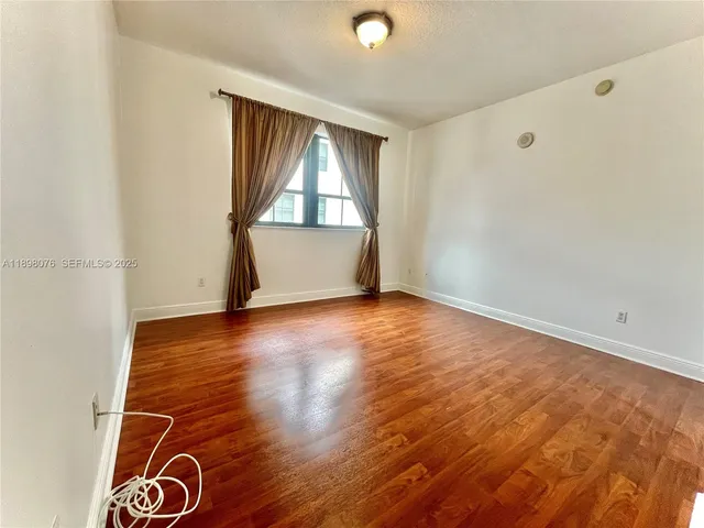 a spacious bathroom with a tub sink mirror and shower