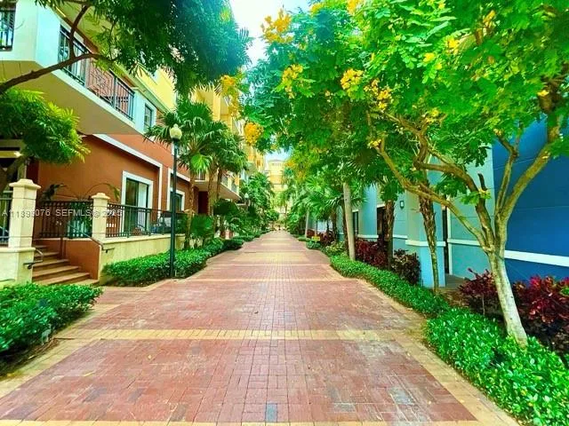 a view of a garden with a building in the background