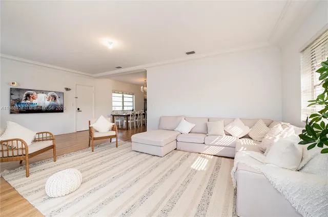 a bedroom with furniture and a large window