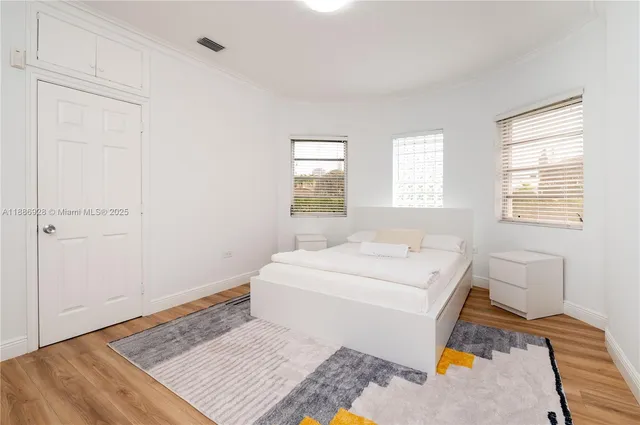 a spacious bedroom with a bed and a window