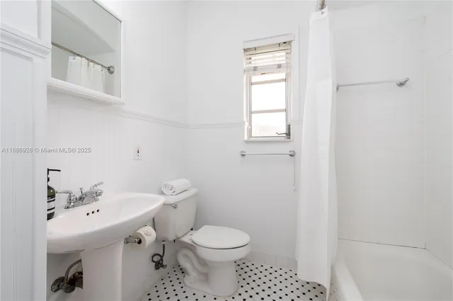 a bathroom with a sink toilet and mirror