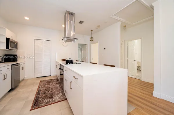 a large kitchen with a stove and a refrigerator