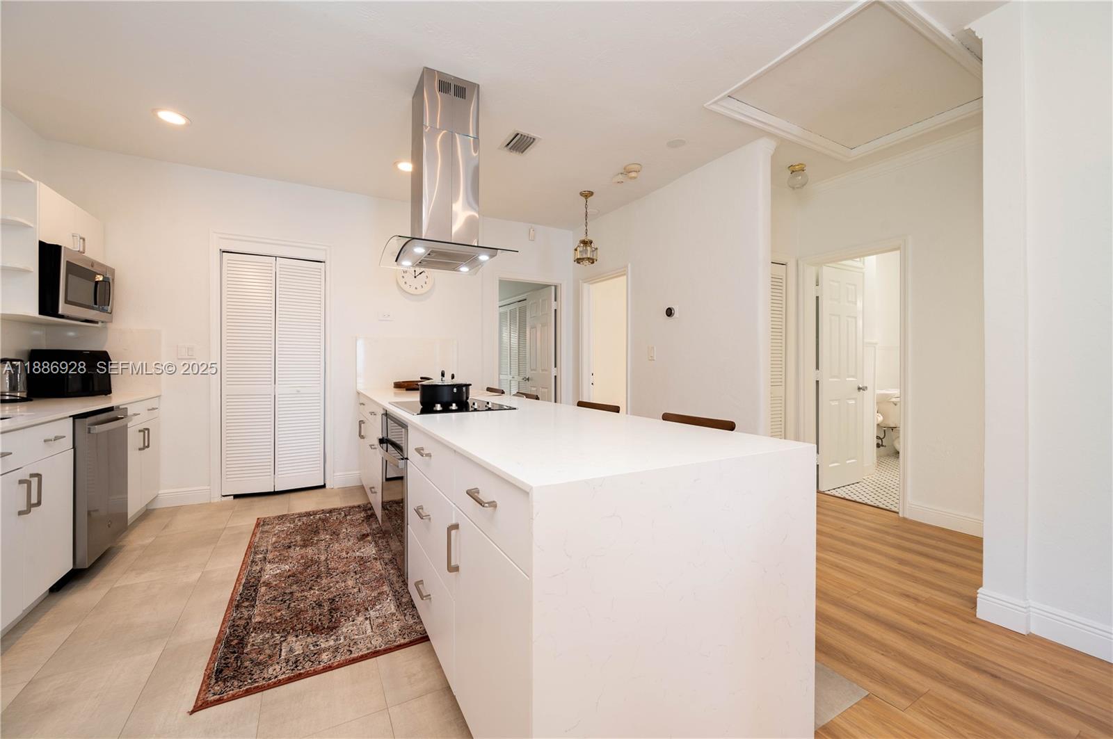 501 Southwest 24th Road, Unit 501 Miami, FL 33129 - Photo 2 of 29 a large kitchen with a stove and a refrigerator