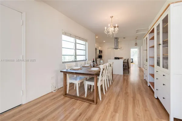 a view of a dining room with furniture window and wooden floor