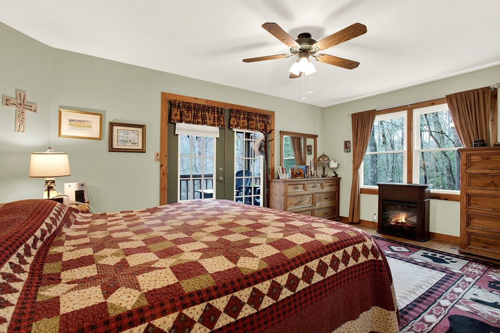 57 Mangum's Trail Blue Ridge, GA 30513 - Photo 29 of 66 a bedroom with a bed and a fireplace