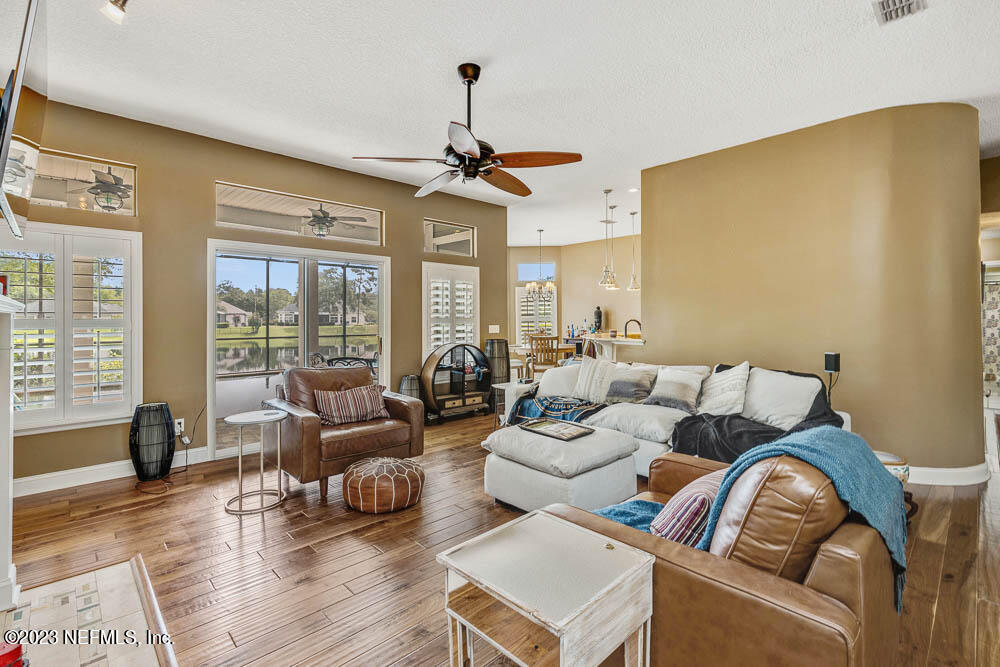 332 Maplewood Drive St. Johns, FL 32259 - Photo 13 of 35 a living room with furniture ceiling fan and a large window