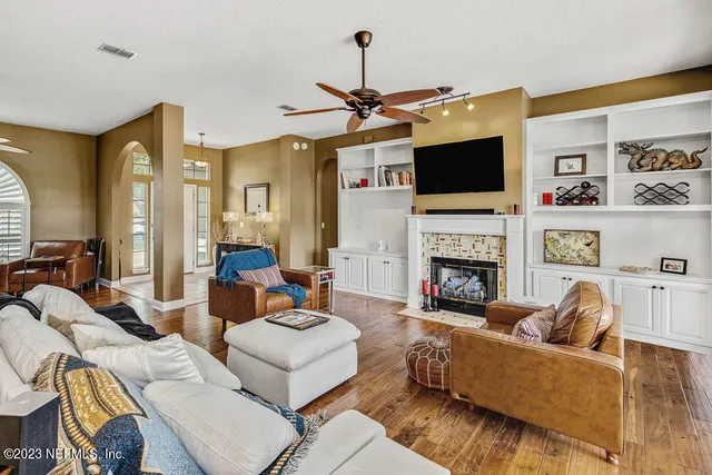 a living room with furniture a flat screen tv and a fireplace