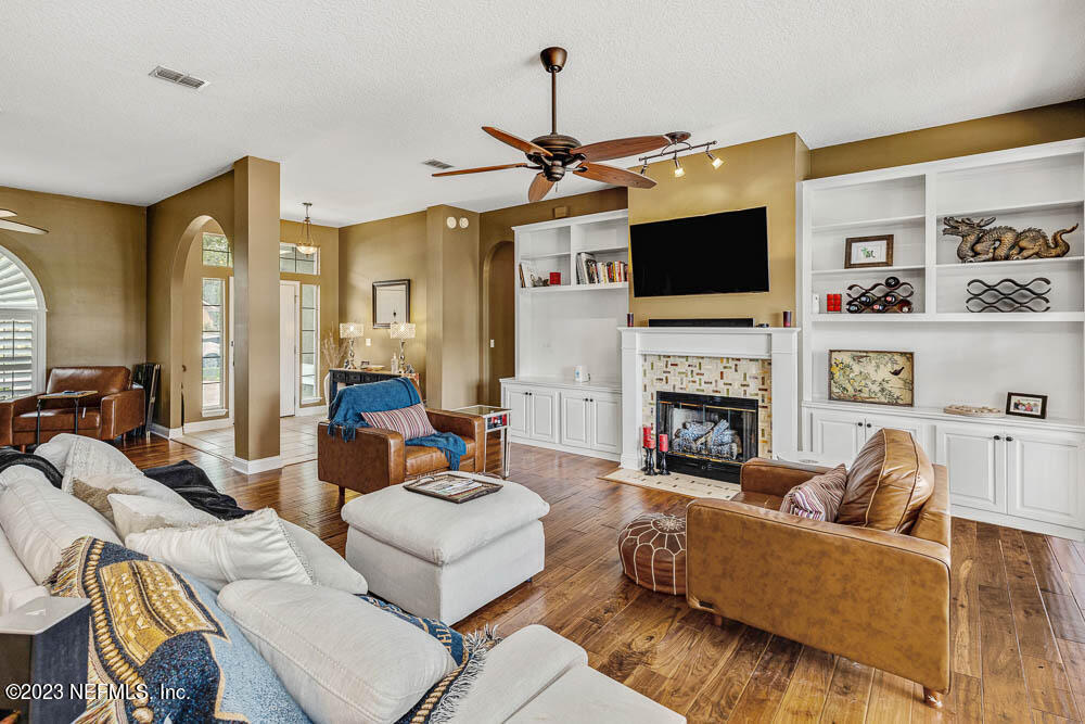 332 Maplewood Drive St. Johns, FL 32259 - Photo 14 of 35 a living room with furniture a flat screen tv and a fireplace