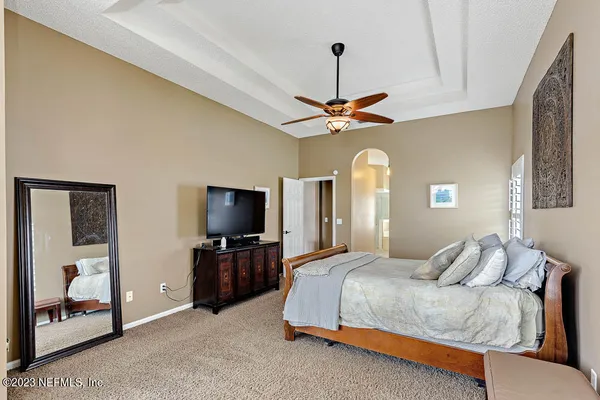 a bedroom with a bed and a chandelier