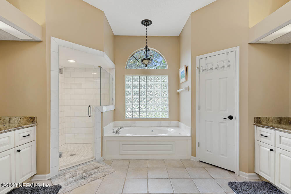 332 Maplewood Drive St. Johns, FL 32259 - Photo 18 of 35 a bathroom with a tub shower and a sink