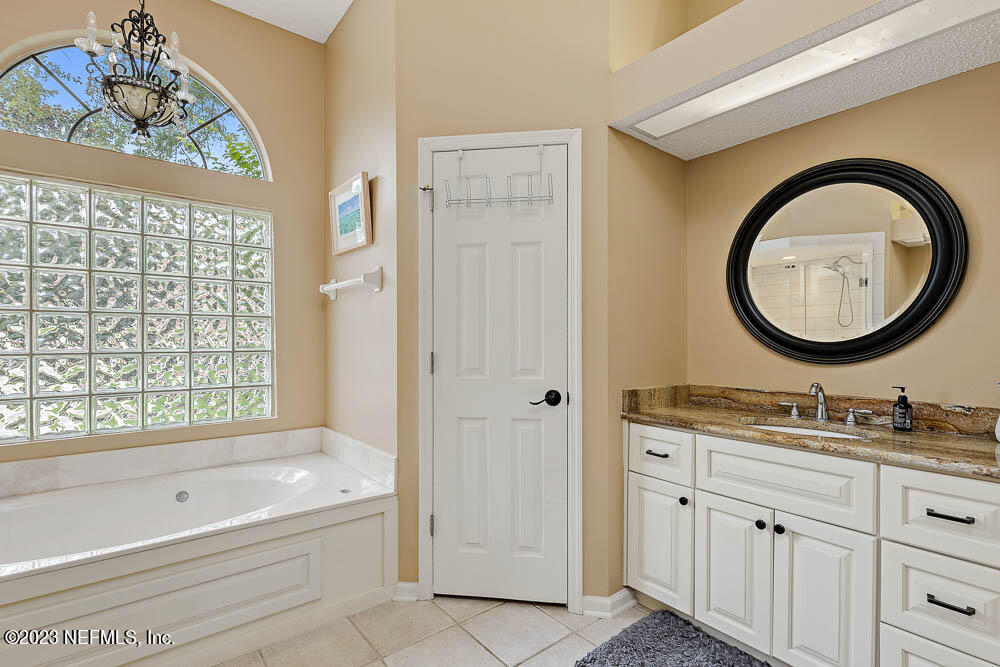 332 Maplewood Drive St. Johns, FL 32259 - Photo 20 of 35 a bathroom with a tub sink and mirror