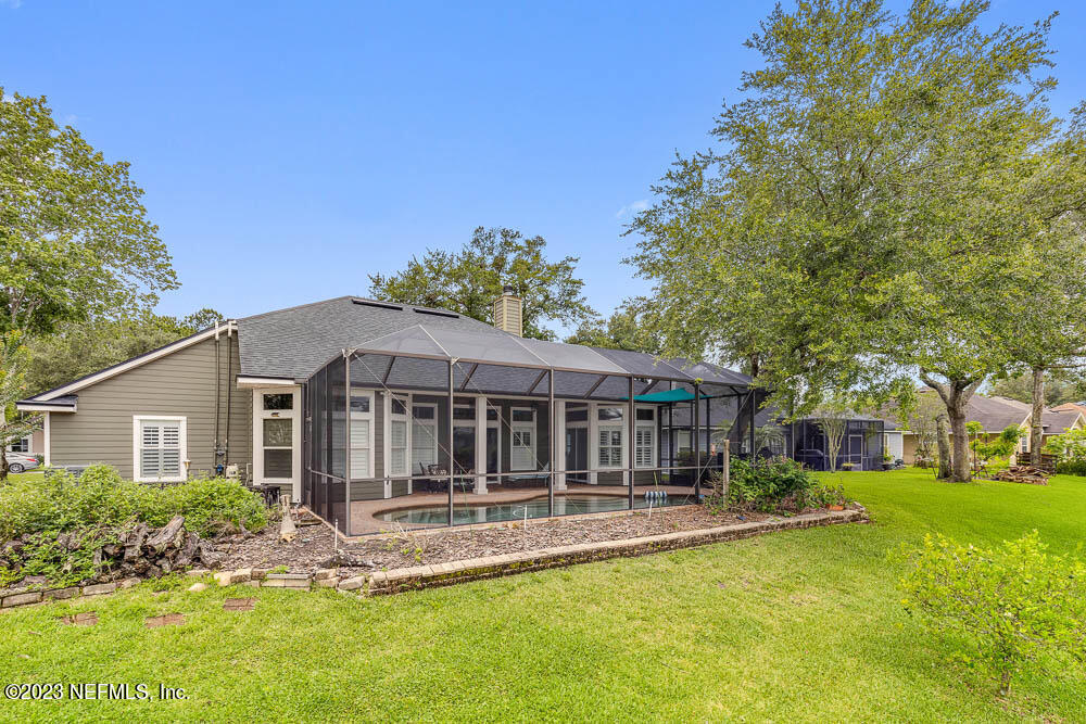 332 Maplewood Drive St. Johns, FL 32259 - Photo 28 of 35 a view of a house with a small yard plants and large tree