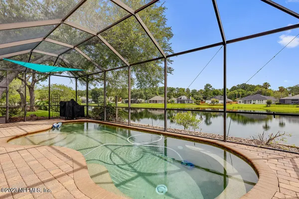 a swimming pool with outdoor seating and yard