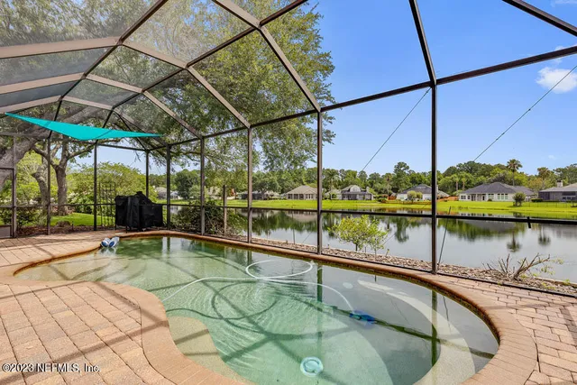 a swimming pool with outdoor seating and yard