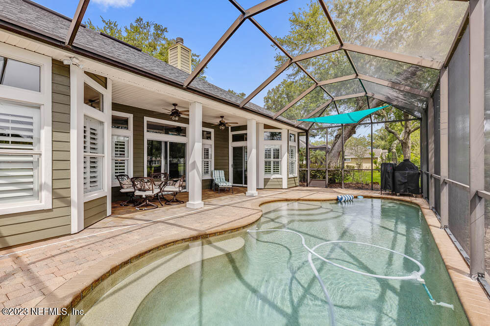 332 Maplewood Drive St. Johns, FL 32259 - Photo 32 of 35 a swimming pool with outdoor seating and yard