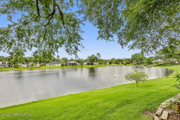 a view of a lake with houses in the back