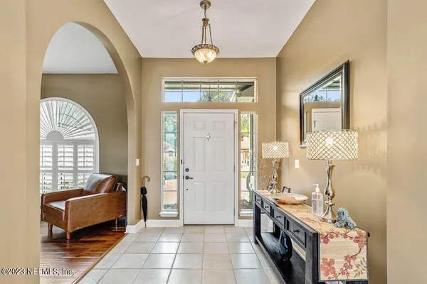 a spacious bathroom with a granite countertop tub sink a mirror a window and a shower
