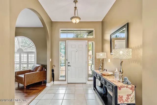 a spacious bathroom with a granite countertop tub sink a mirror a window and a shower