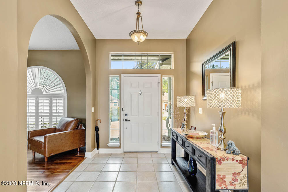 332 Maplewood Drive St. Johns, FL 32259 - Photo 5 of 35 a spacious bathroom with a granite countertop tub sink a mirror a window and a shower