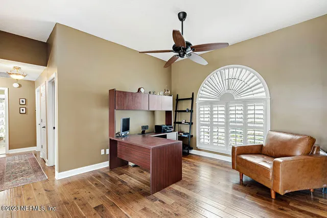 a livingroom with workspace window and a wooden floor