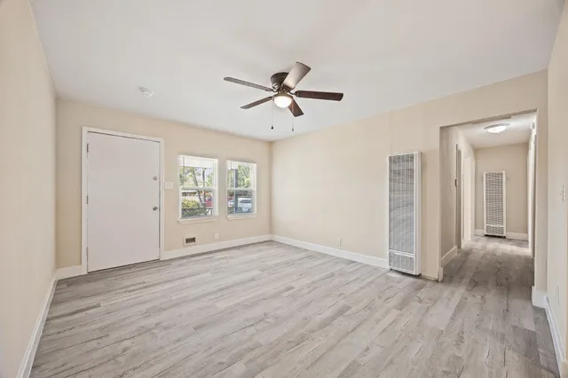 wooden floor in an empty room with a window
