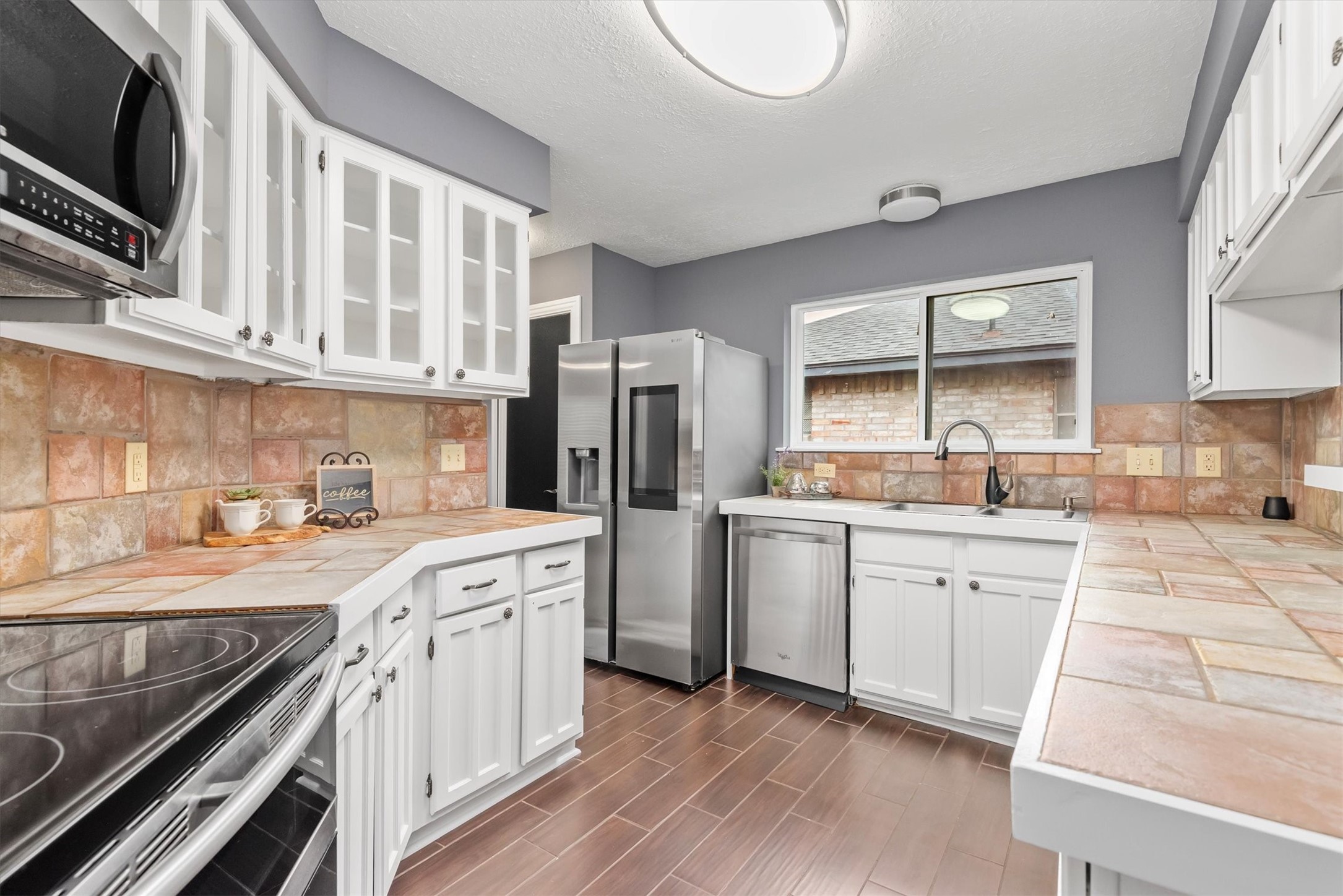6510 Barrygate Drive Spring, TX 77373 - Photo 7 of 25 a kitchen with a sink stove and cabinets