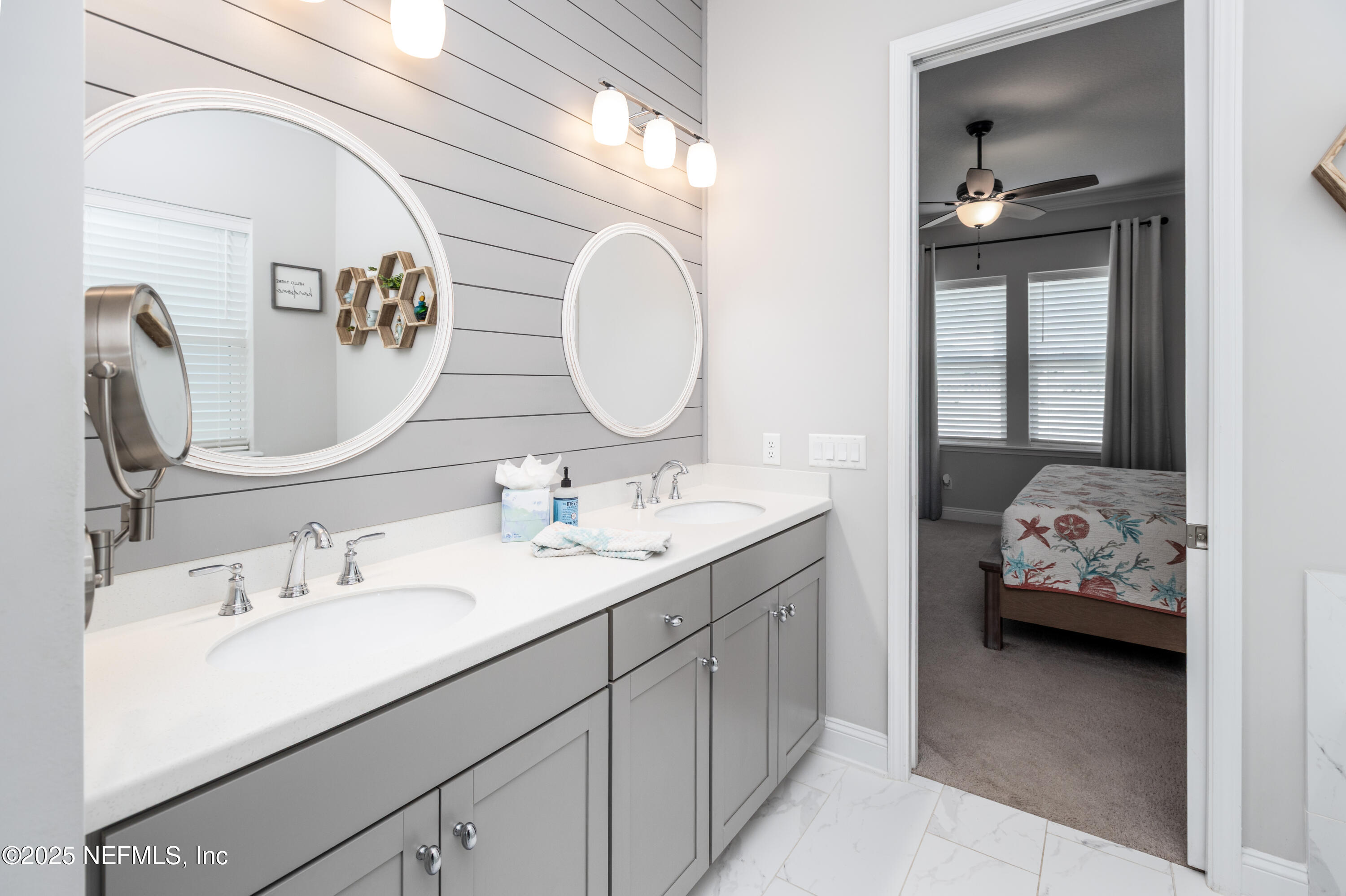 103 Tarbert Lane St. Augustine, FL 32092 - Photo 19 of 44 a en suite bathroom with a double vanity sink and a mirror