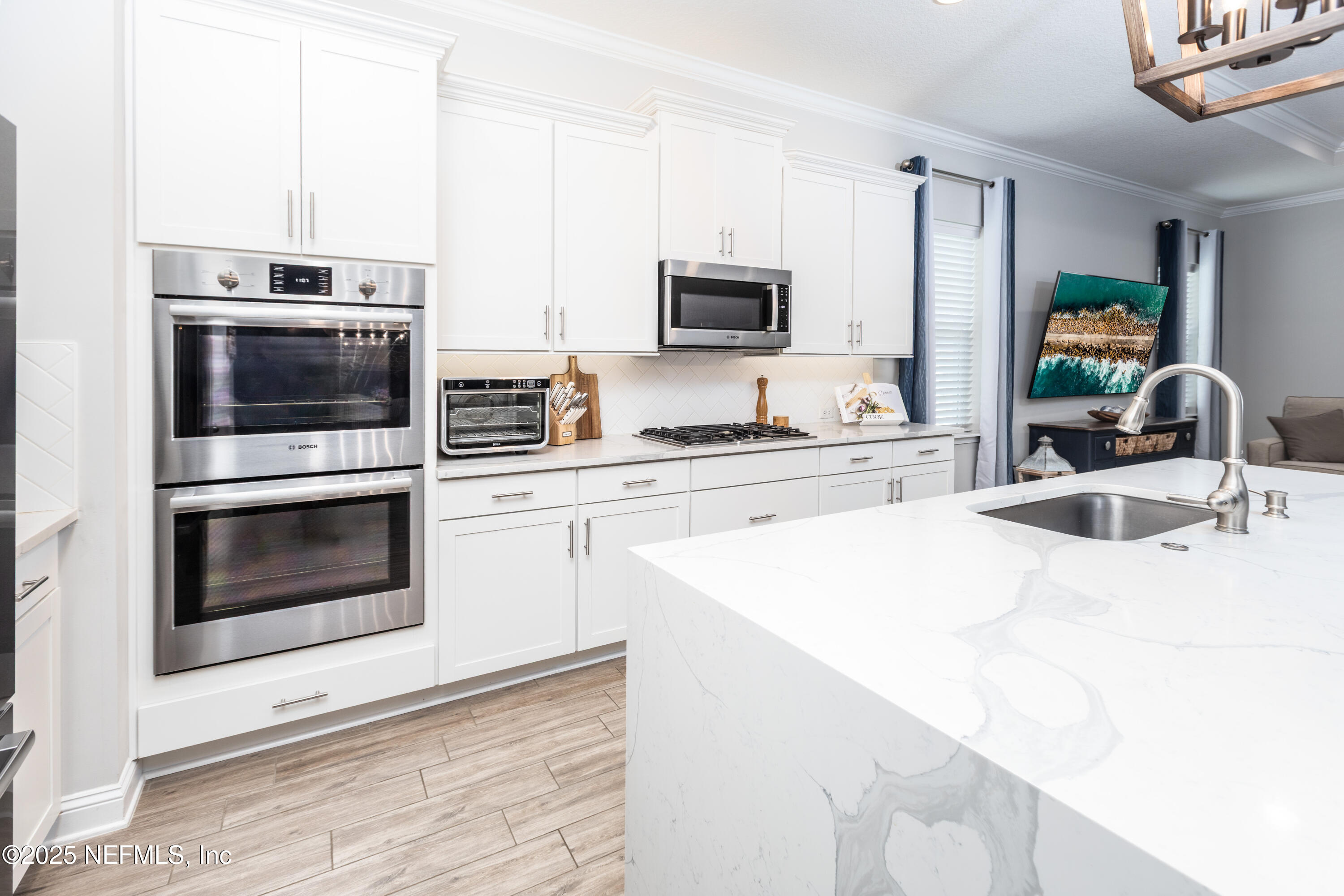103 Tarbert Lane St. Augustine, FL 32092 - Photo 5 of 44 a kitchen with stainless steel appliances a stove microwave and sink