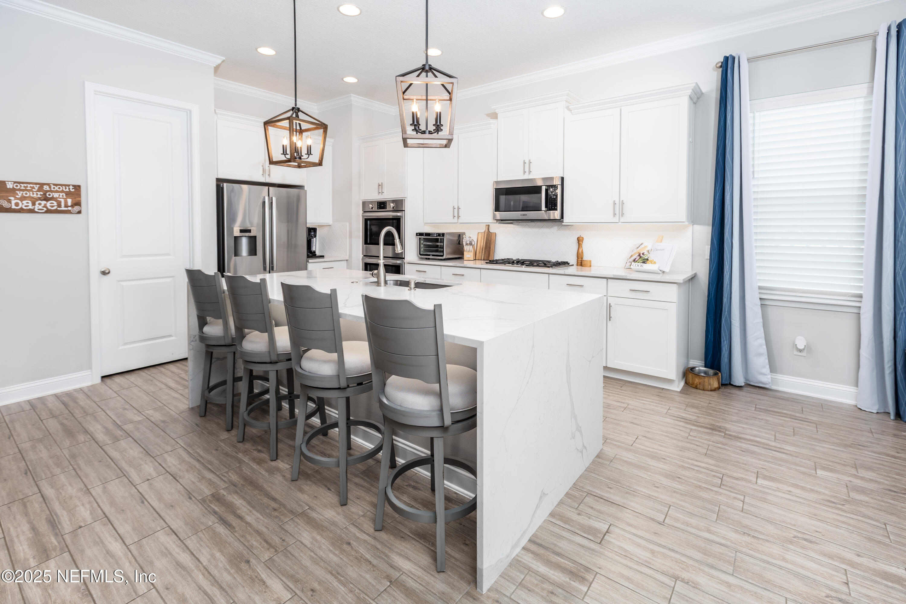 103 Tarbert Lane St. Augustine, FL 32092 - Photo 6 of 44 a kitchen with stainless steel appliances kitchen island granite countertop a table chairs and a refrigerator