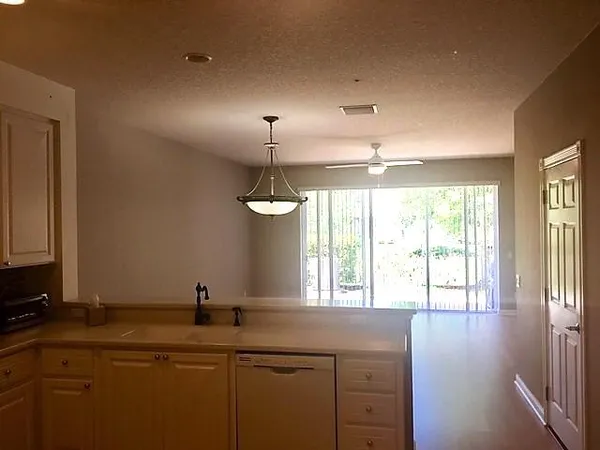 a view of a sink and dishwasher with wooden floor