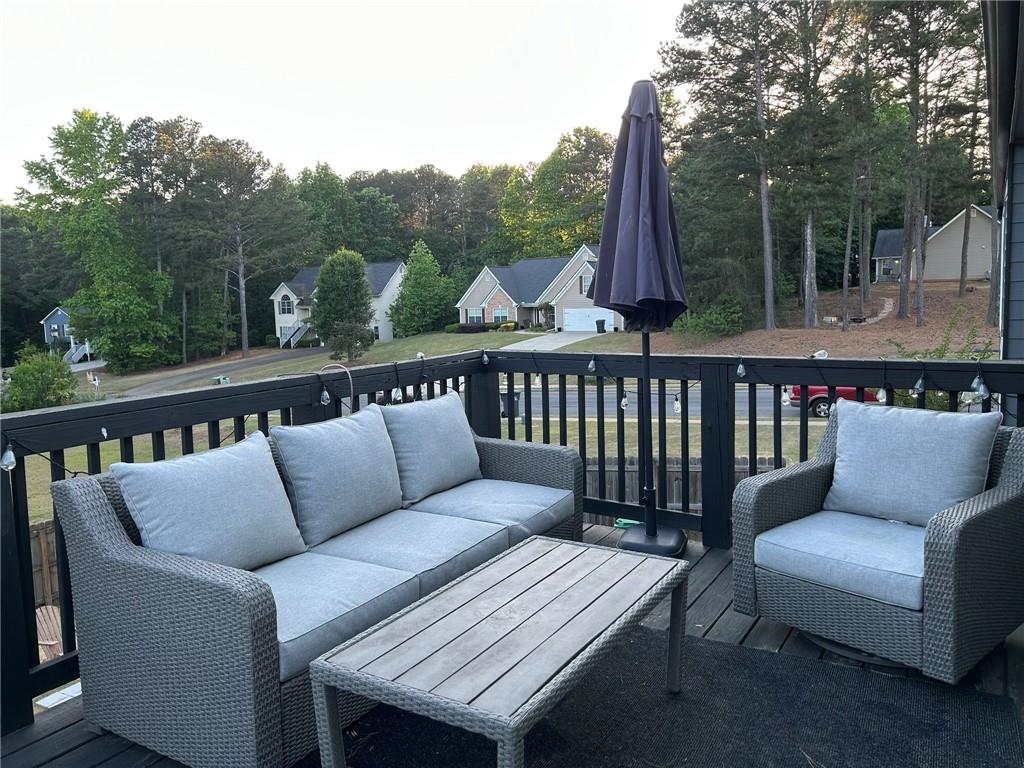 4197 Wyndham Ridge Court Northeast Buford, GA 30519 - Photo 13 of 49 a balcony with wooden floor and outdoor seating