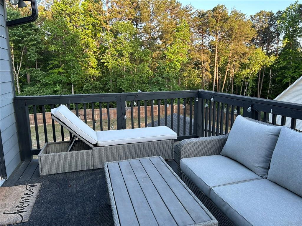 4197 Wyndham Ridge Court Northeast Buford, GA 30519 - Photo 14 of 49 a balcony with wooden floor stairs and bench