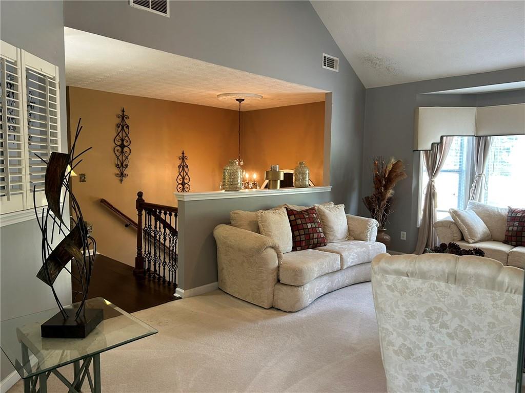 4197 Wyndham Ridge Court Northeast Buford, GA 30519 - Photo 16 of 49 a living room with furniture a window and gym cycle