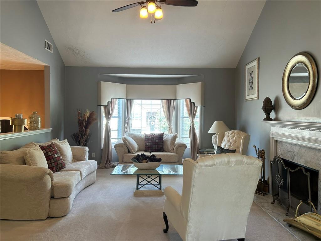 4197 Wyndham Ridge Court Northeast Buford, GA 30519 - Photo 18 of 49 a living room with furniture a fireplace and a flat screen tv
