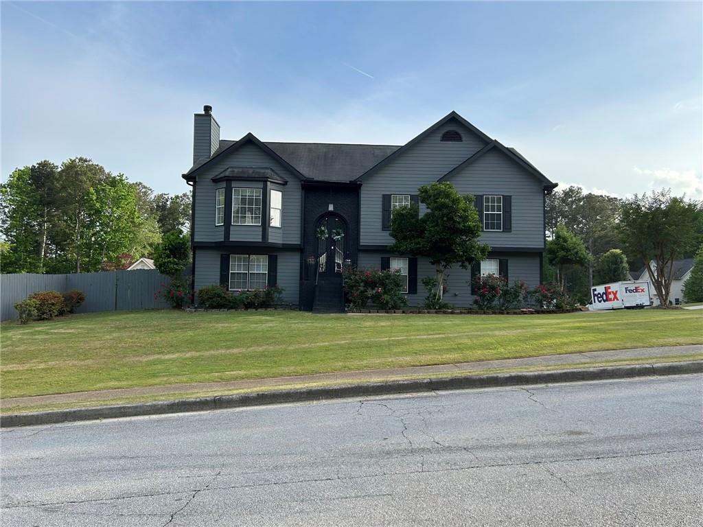 4197 Wyndham Ridge Court Northeast Buford, GA 30519 - Photo 2 of 49 a front view of a house with a yard and garage