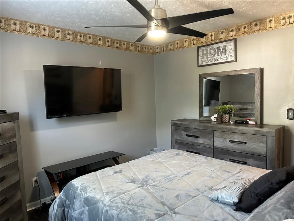 4197 Wyndham Ridge Court Northeast Buford, GA 30519 - Photo 23 of 49 a bedroom with a bed and a flat screen tv