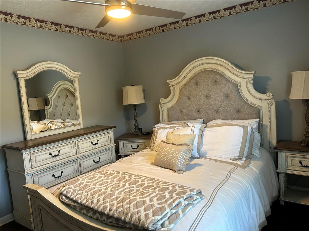 4197 Wyndham Ridge Court Northeast Buford, GA 30519 - Photo 26 of 49 a bedroom with a bed and a dresser