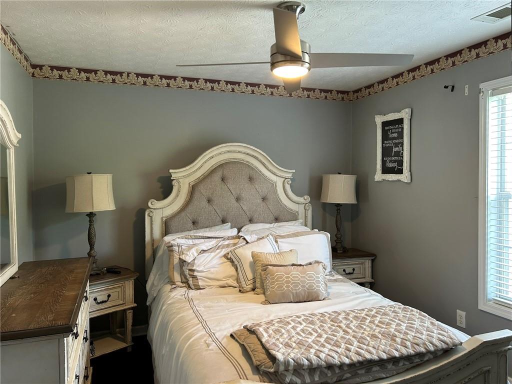 4197 Wyndham Ridge Court Northeast Buford, GA 30519 - Photo 27 of 49 a bedroom with a bed and a table